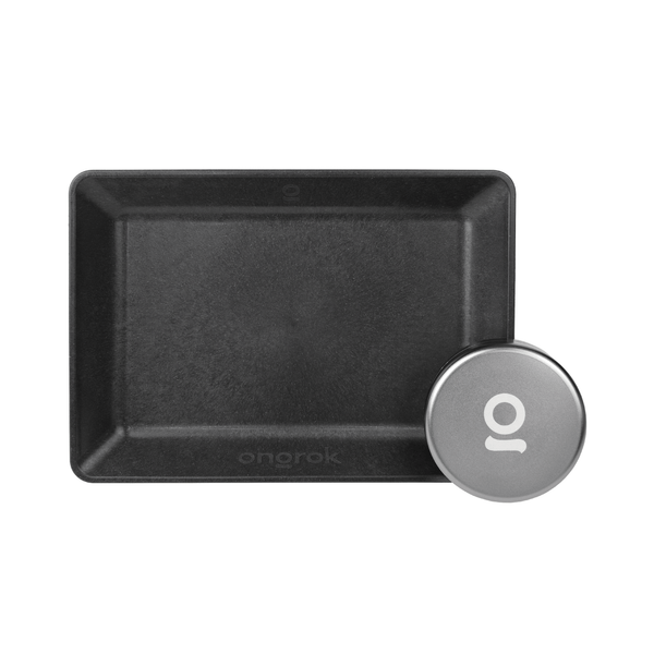 ONGROK Eco-Tray in black molded plant fiber beside a silver Storage Puck